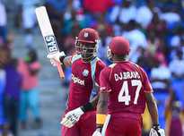West Indies batsman Darren Sammy celebrates a quick half century with Dwayne Bravo during the first One Day International match bewteen West Indies and England at the Sir Vivian Richard Stadium in St John's, February 28, 2014